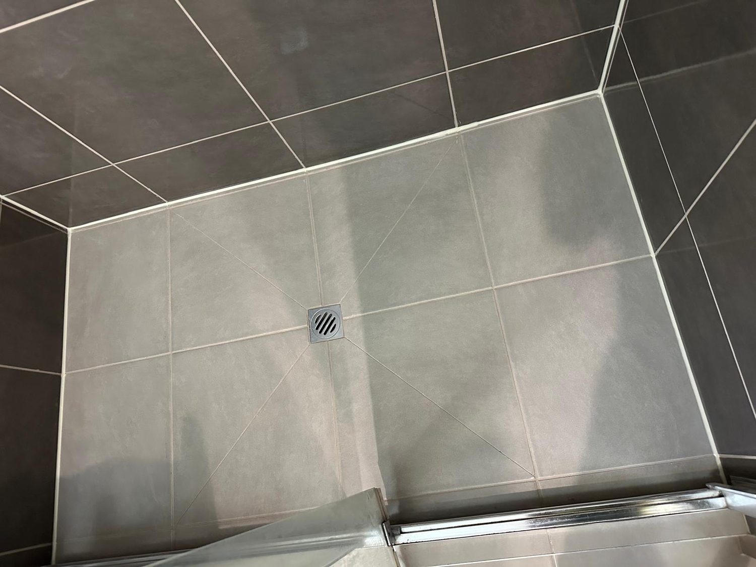 Regrouted shower floor with clean grout lines