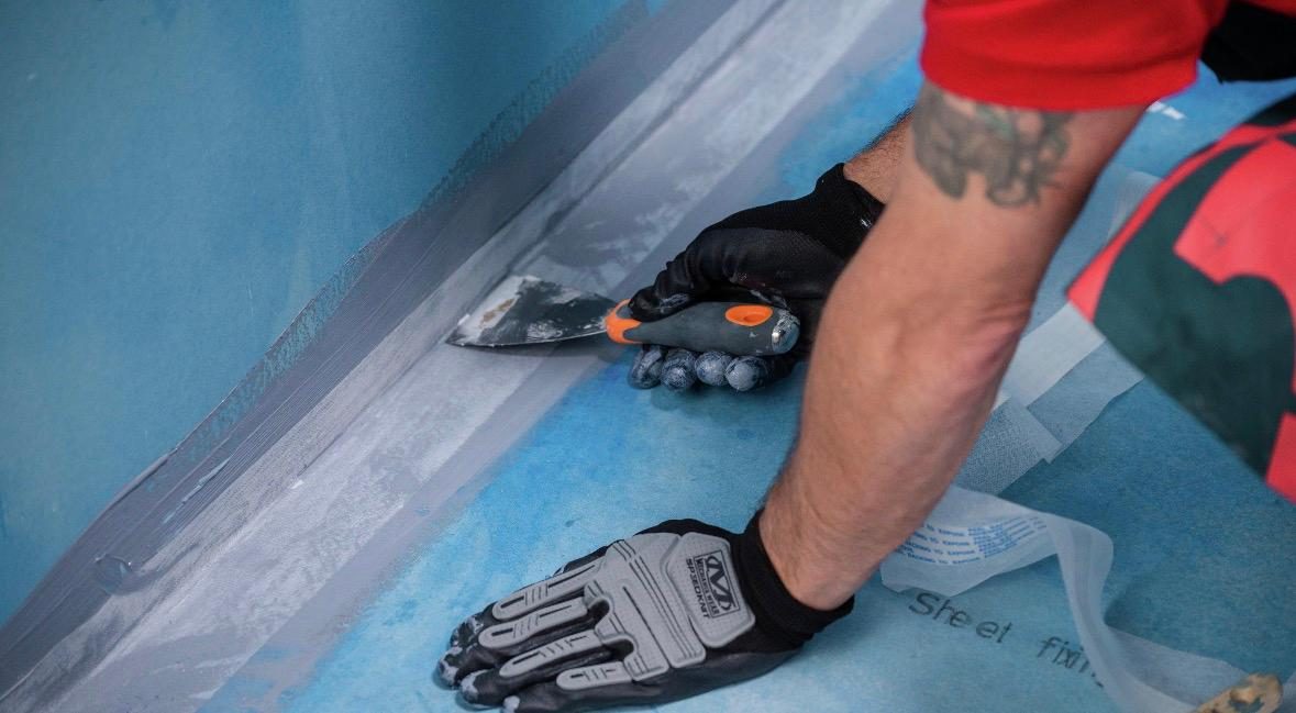 Waterproofing membrane being applied before tiling